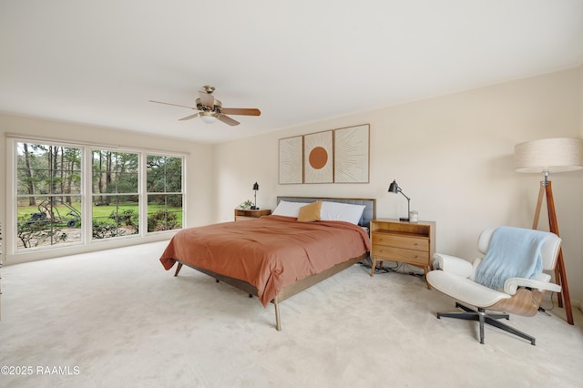 bedroom with ceiling fan and light colored carpet