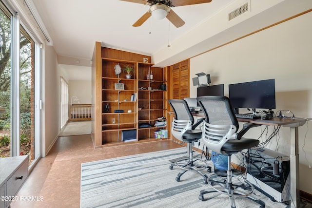 home office with ceiling fan, crown molding, visible vents, and baseboards