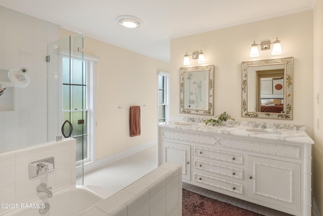 ensuite bathroom with a wealth of natural light, a sink, and ensuite bath