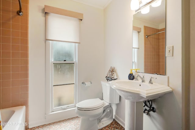 full bathroom featuring a shower, crown molding, and toilet