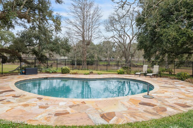 view of swimming pool featuring a fenced in pool, a patio, and fence