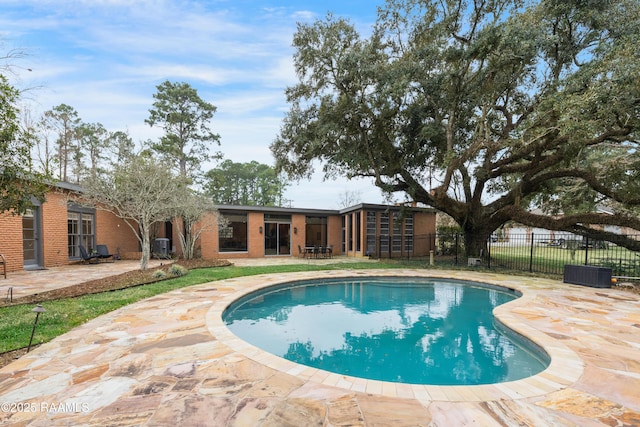 view of pool with a fenced in pool, a patio area, and fence