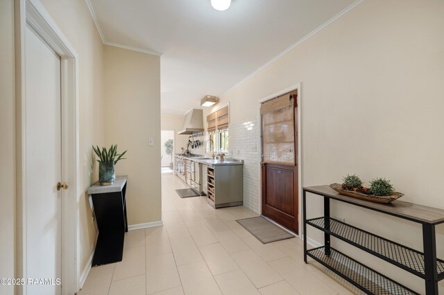 corridor featuring crown molding and baseboards