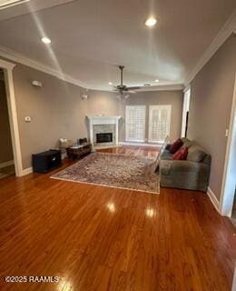 unfurnished living room featuring ceiling fan, crown molding, and hardwood / wood-style floors