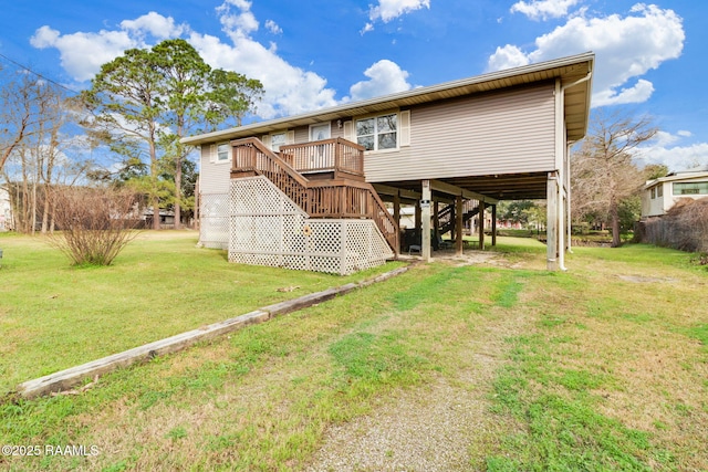 back of house featuring a lawn and a deck