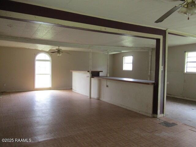 unfurnished room with ceiling fan and light parquet flooring