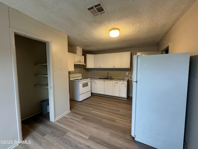 kitchen featuring sink, a textured ceiling, light wood-type flooring, white appliances, and white cabinets