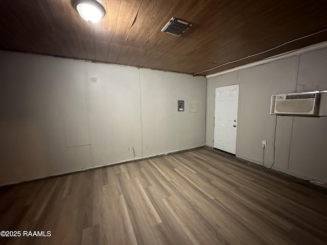 basement with wood-type flooring, a wall mounted AC, and wood ceiling