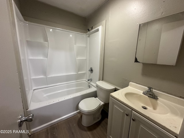 full bathroom with hardwood / wood-style flooring, vanity, shower / washtub combination, and toilet