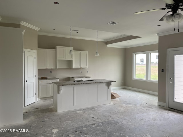 kitchen with crown molding, decorative light fixtures, a kitchen island, and white cabinets