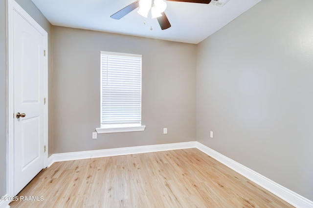 empty room featuring ceiling fan, light wood-style flooring, and baseboards