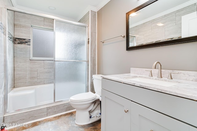 bathroom with ornamental molding, a tile shower, vanity, and toilet