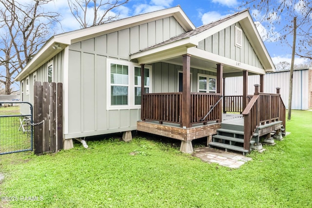 exterior space featuring board and batten siding, roof with shingles, and a lawn