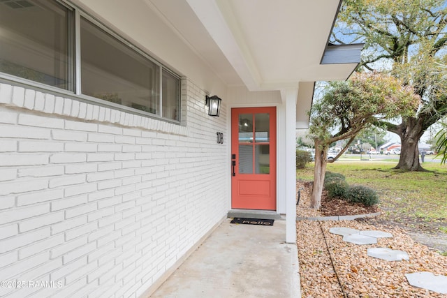 property entrance with brick siding