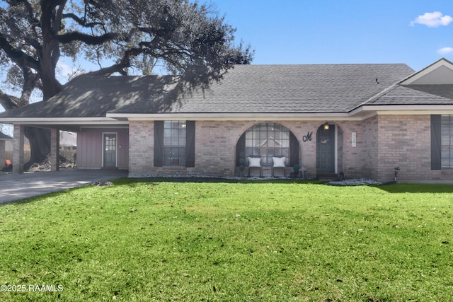 ranch-style home featuring a shingled roof, brick siding, and a front lawn