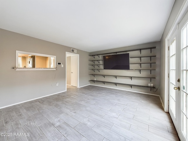 unfurnished living room with french doors