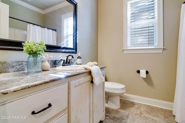 full bath featuring toilet, ornamental molding, vanity, and baseboards