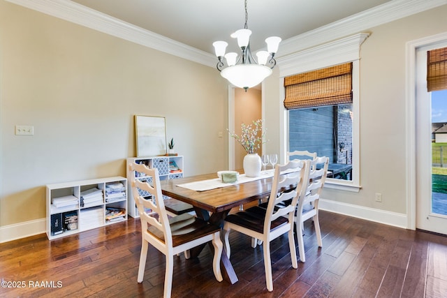 dining space with dark wood-style flooring, baseboards, a healthy amount of sunlight, ornamental molding, and an inviting chandelier