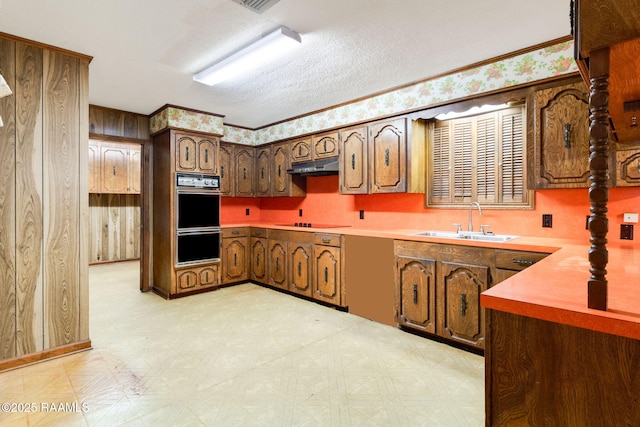 kitchen featuring sink, a textured ceiling, and black appliances