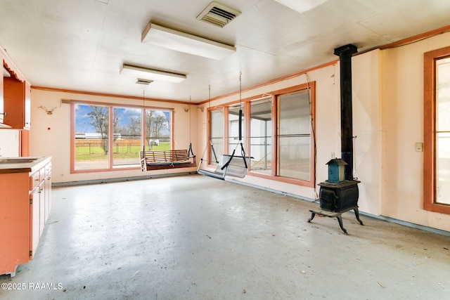 interior space with sink and a wood stove