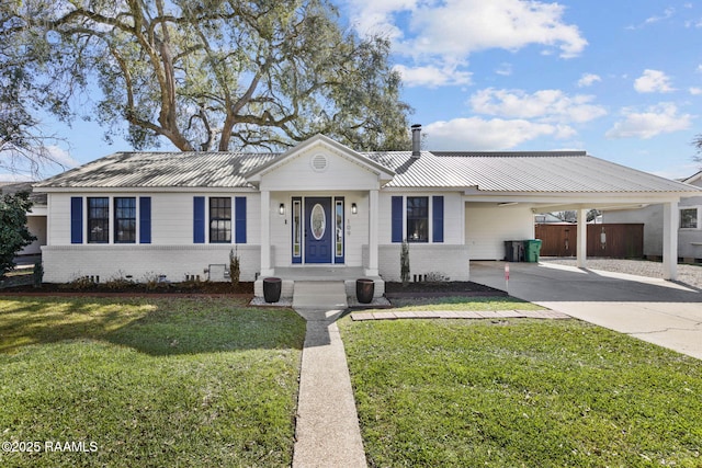 single story home featuring driveway, brick siding, metal roof, crawl space, and a front yard