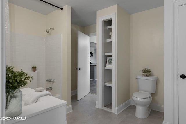 full bathroom featuring tile patterned floors, shower / tub combination, toilet, and baseboards