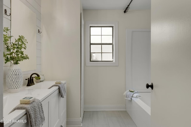 full bathroom featuring baseboards and vanity