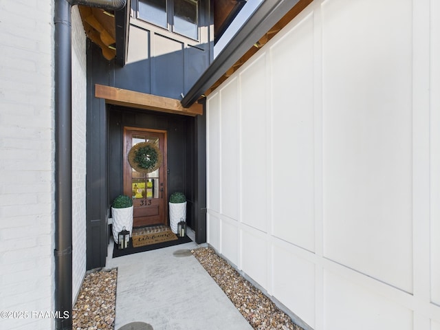 entrance to property featuring brick siding