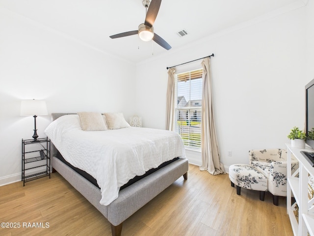 bedroom featuring baseboards, visible vents, and light wood finished floors