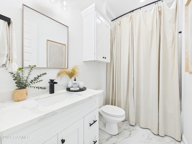 full bath featuring vanity, toilet, and marble finish floor