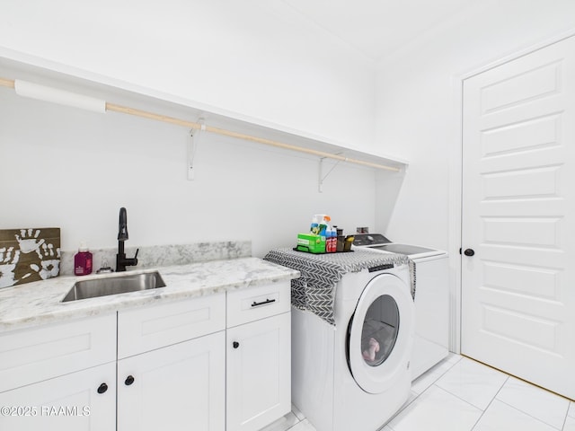 clothes washing area featuring cabinet space, light tile patterned floors, independent washer and dryer, and a sink