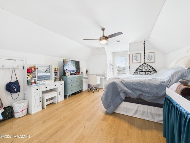 bedroom featuring ceiling fan, visible vents, light wood-style flooring, and vaulted ceiling