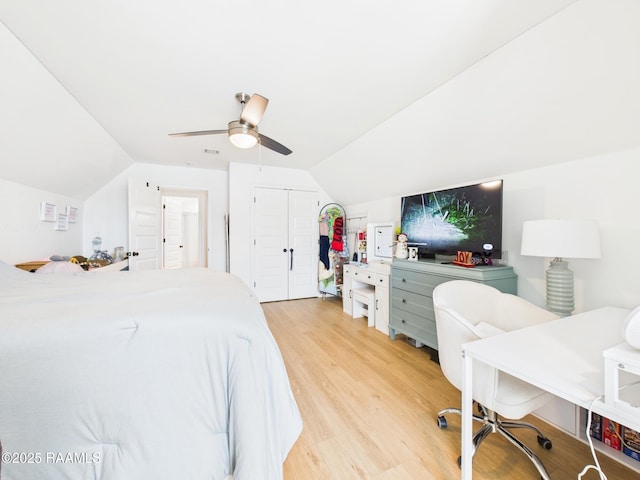 bedroom with a closet, light wood-style flooring, a ceiling fan, and lofted ceiling