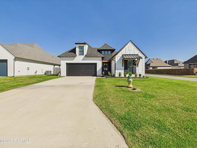 view of front of house featuring driveway, a front lawn, a standing seam roof, central AC, and fence