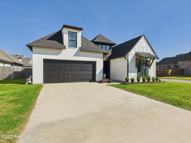 modern farmhouse featuring an attached garage, a front yard, and fence