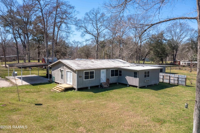 exterior space featuring a front lawn and a carport