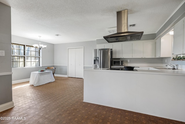 kitchen featuring stainless steel appliances, hanging light fixtures, sink, white cabinets, and island range hood