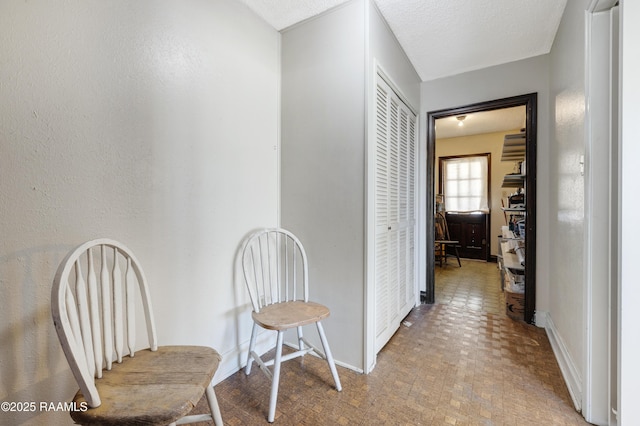 corridor with a textured ceiling