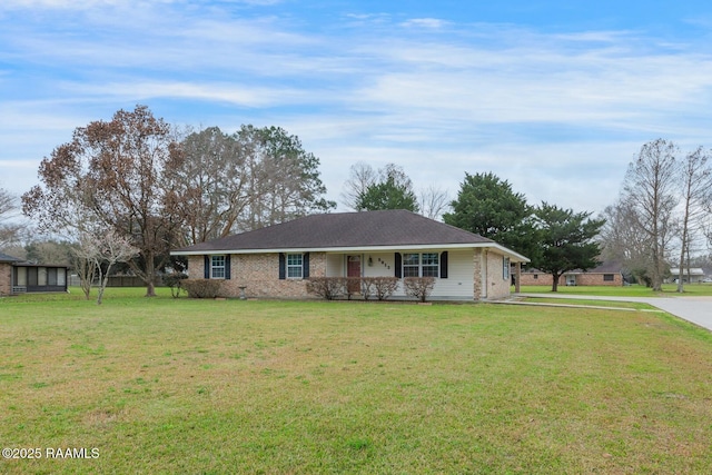 ranch-style home with covered porch and a front lawn