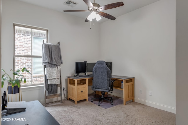 office space with carpet, visible vents, ceiling fan, and baseboards