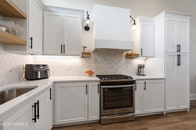 kitchen with open shelves, stainless steel range with gas cooktop, white cabinetry, and light countertops