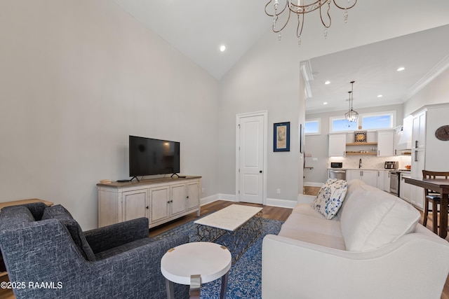 living area with high vaulted ceiling, recessed lighting, baseboards, and wood finished floors