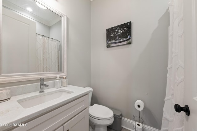 full bathroom with toilet, baseboards, and vanity