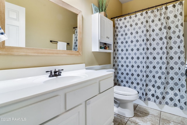 full bathroom with toilet, tile patterned flooring, and vanity