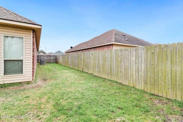 view of yard featuring a fenced backyard and central AC unit