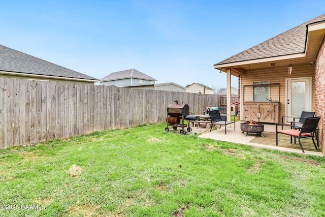 view of yard featuring an outdoor fire pit, a patio area, and a fenced backyard