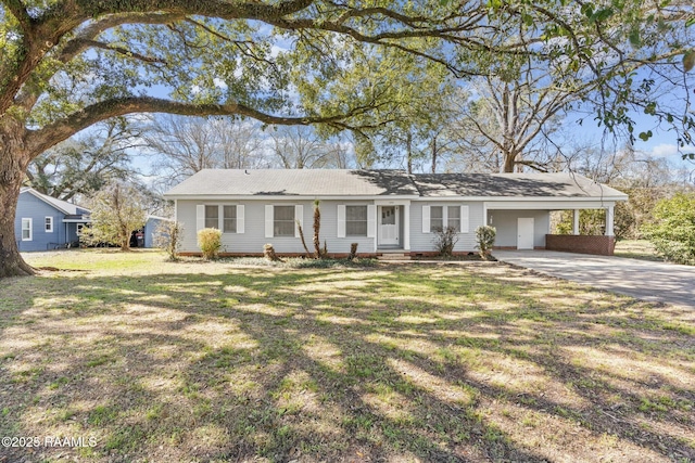 ranch-style home featuring a carport, concrete driveway, and a front yard