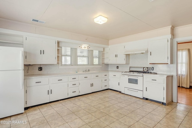 kitchen with visible vents, light countertops, white cabinets, white appliances, and open shelves