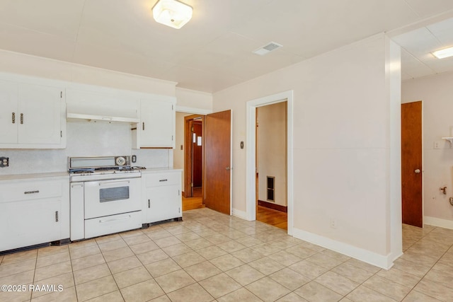 kitchen with white cabinets, ventilation hood, light countertops, and white gas range oven