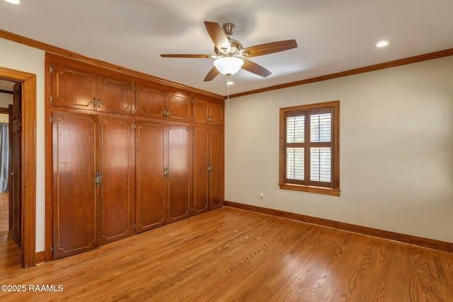 unfurnished bedroom with crown molding, baseboards, light wood-type flooring, a closet, and a ceiling fan